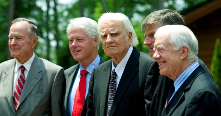 FILE PHOTO: Former U.S. presidents, H.W. Bush, Clinton and Carter, pose with evangelist Billy Graham and Franklin Graham before the Billy Graham Library Dedication on the campus of the Billy Graham Evangelistic Association in Charlotte